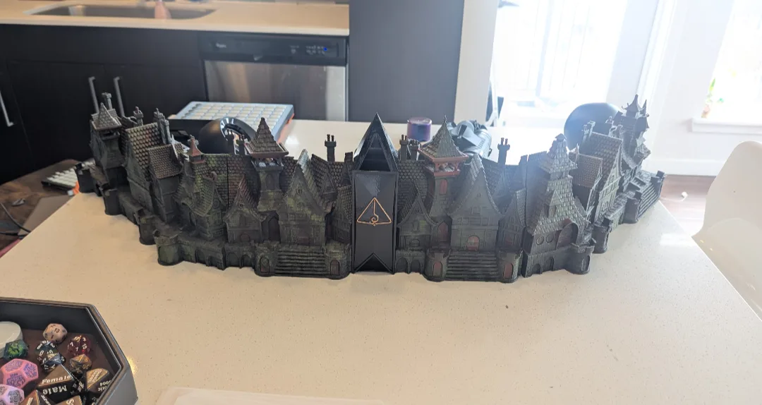 The castle-shaped DM screen I built, with the Last Light sigil on the tower
